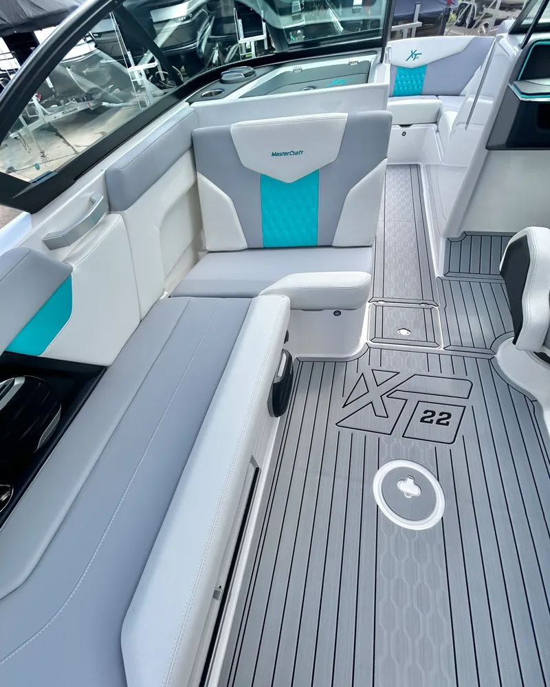 Slide: The Image of Interior of 2026 MasterCraft XT22 boat with gray and blue seating. - 32