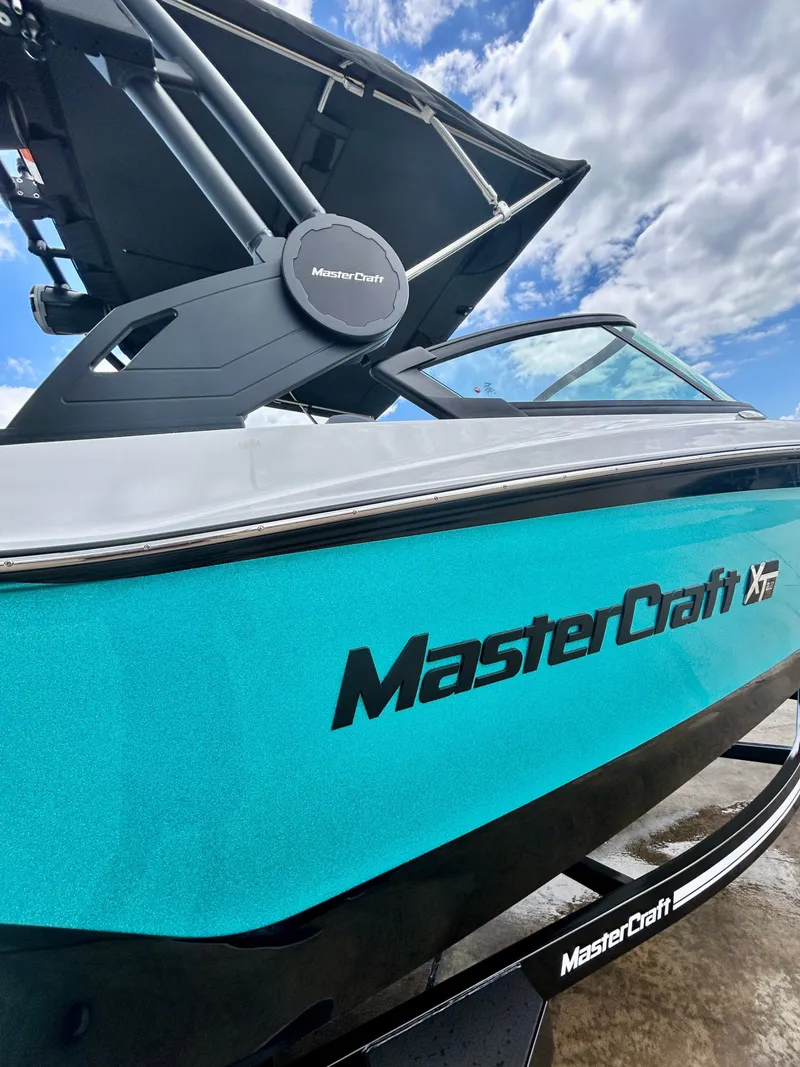 Slide: The Image of 2026 MasterCraft XT22 boat with blue hull and modern design. - 5