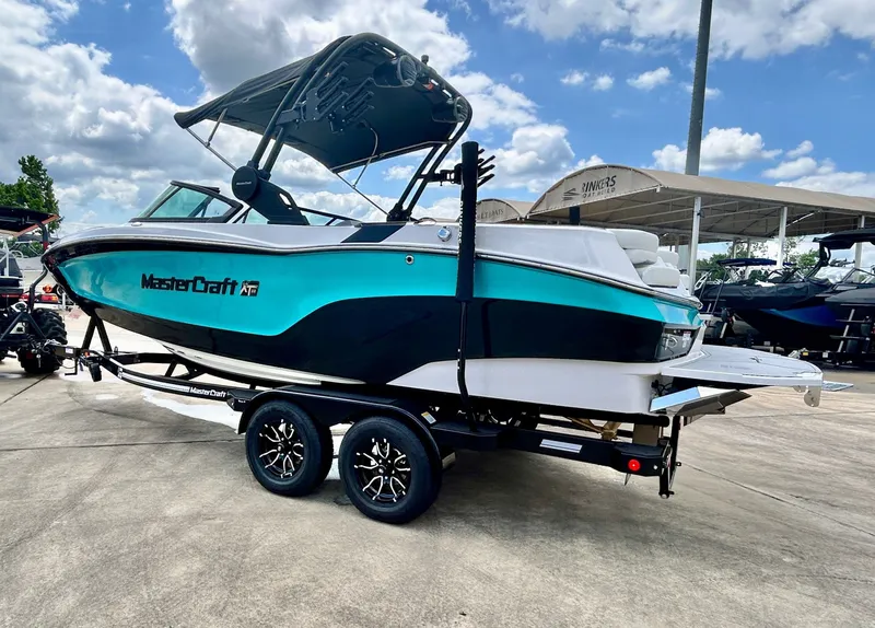 Slide: The Image of 2026 MasterCraft XT22 boat on trailer in sunny weather. - 9