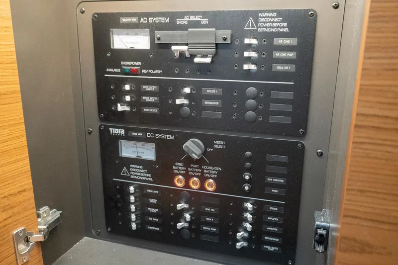 Slide: The Image of Electrical control panel of a 2026 Tiara Yachts 34 LS, featuring AC and DC systems. - 15