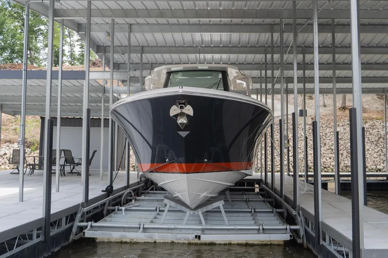 Slide: The Image of 2026 Tiara Yachts 34 LS docked in a covered marina slip. - 2