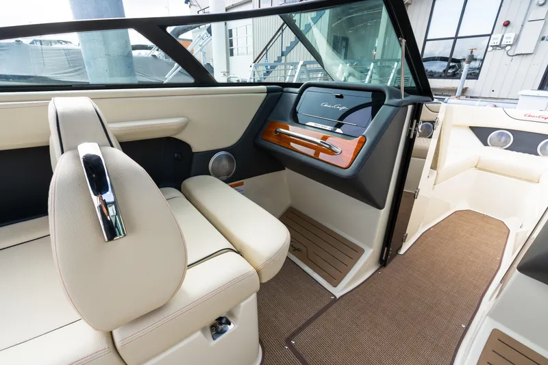 Slide: The Image of 2025 Chris-Craft Sportster 25 interior with luxurious seating and elegant dashboard design. - 10