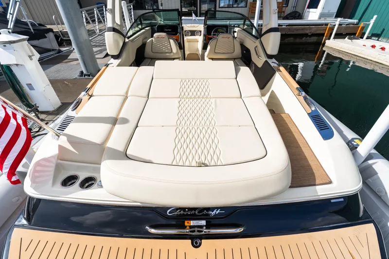 Slide: The Image of 2025 Chris-Craft Sportster 25 boat with luxurious seating at a marina dock. - 15