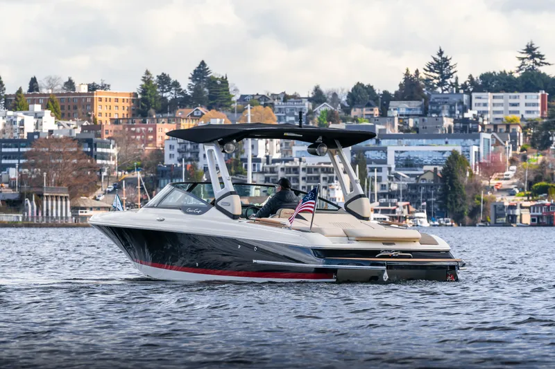 Slide: The Image of 2025 Chris-Craft Sportster 25 boat cruising on a scenic urban waterfront. - 4
