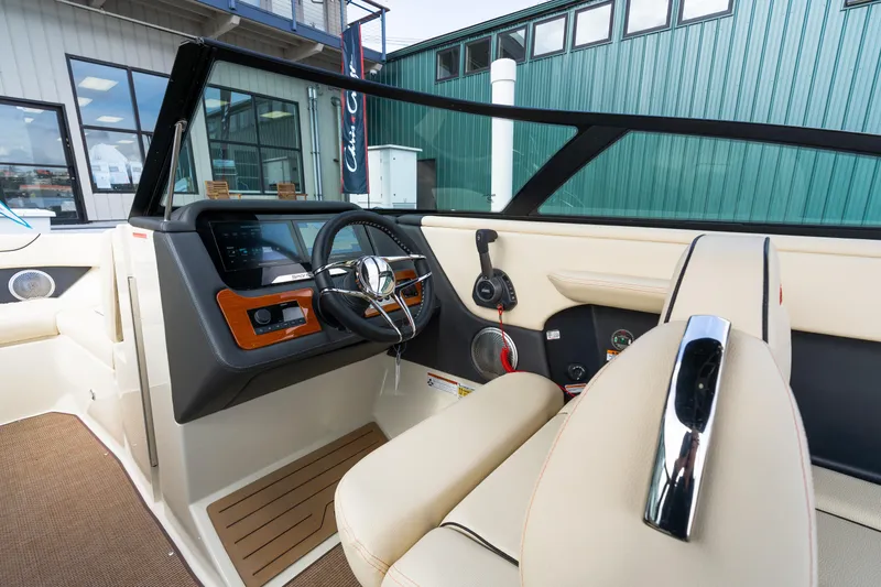 Slide: The Image of Interior view of 2025 Chris-Craft Sportster 25 boat, featuring modern dashboard and steering wheel. - 8