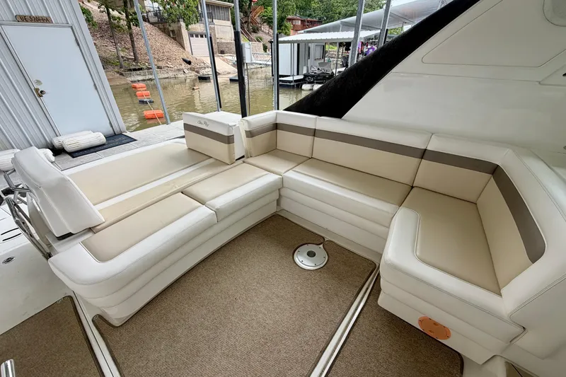 Slide: The Image of Luxurious seating area on a 2012 Sea Ray 450 Sundancer yacht, docked by the water. - 10