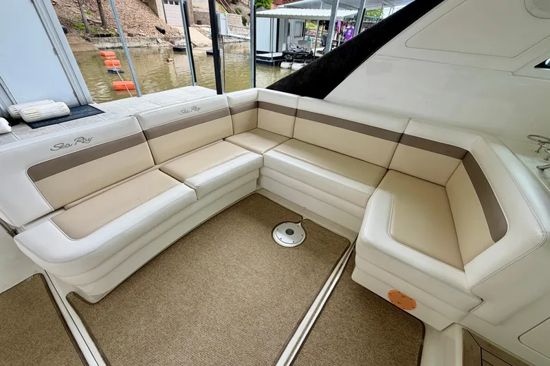 Slide: The Image of Luxurious seating area on a 2012 Sea Ray 450 Sundancer yacht, docked by the water. - 11