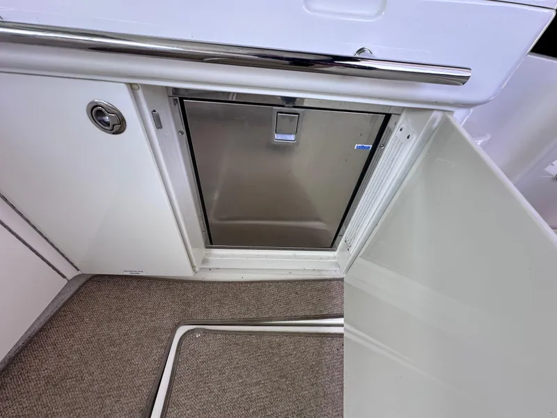 Slide: The Image of 2012 Sea Ray 450 Sundancer interior with stainless steel appliance and carpeted flooring. - 17