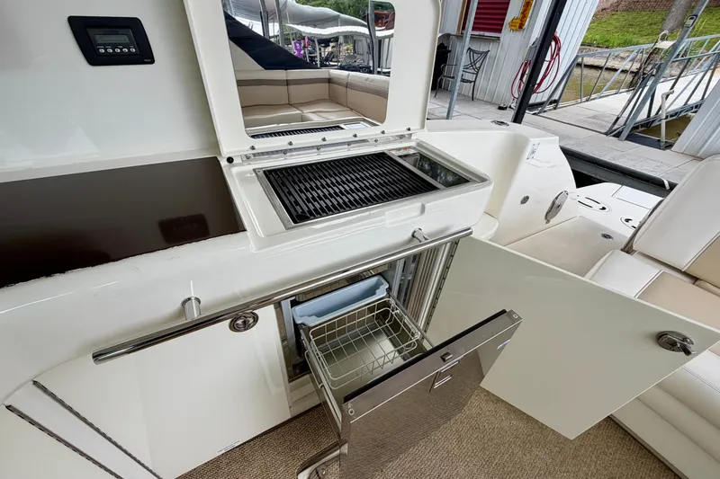 Slide: The Image of Outdoor kitchen area on a 2012 Sea Ray 450 Sundancer yacht with grill and storage. - 18