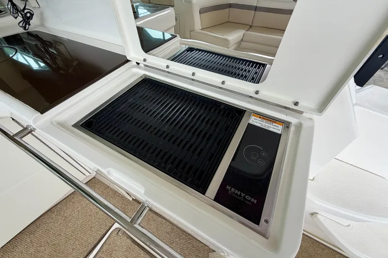 Slide: The Image of Outdoor grill on 2012 Sea Ray 450 Sundancer yacht, featuring Kenyon electric cooktop. - 19