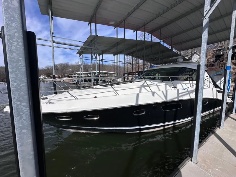 Slide: The Image of 2012 Sea Ray 450 Sundancer yacht docked under covered marina. - 2