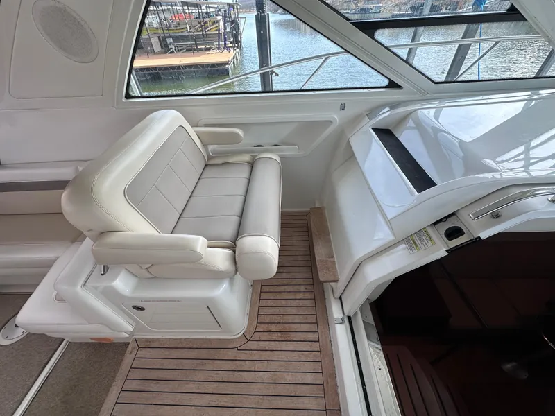 Slide: The Image of Interior of 2012 Sea Ray 450 Sundancer with white seating and wooden flooring. - 23