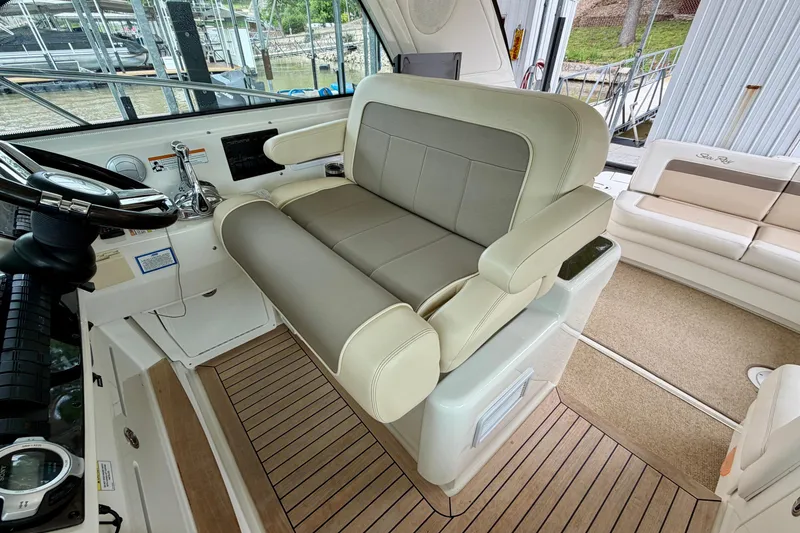 Slide: The Image of Interior helm seating of 2012 Sea Ray 450 Sundancer yacht with beige upholstery. - 24