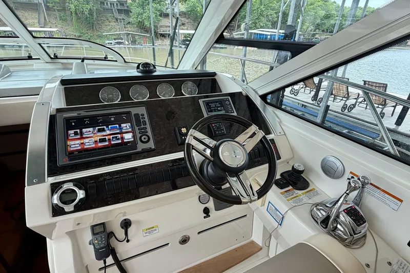Slide: The Image of Helm of 2012 Sea Ray 450 Sundancer with modern controls and navigation displays. - 25