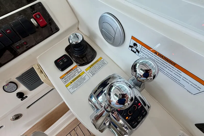 Slide: The Image of Control panel of a 2012 Sea Ray 450 Sundancer boat with warning labels. - 26