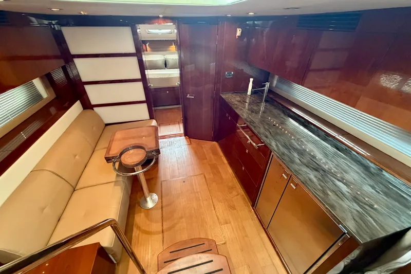 Slide: The Image of Luxurious interior of 2012 Sea Ray 450 Sundancer yacht with modern kitchen and seating area. - 27