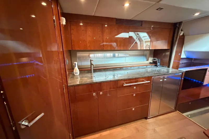 Slide: The Image of Luxurious kitchen interior of 2012 Sea Ray 450 Sundancer yacht with wooden cabinetry. - 29