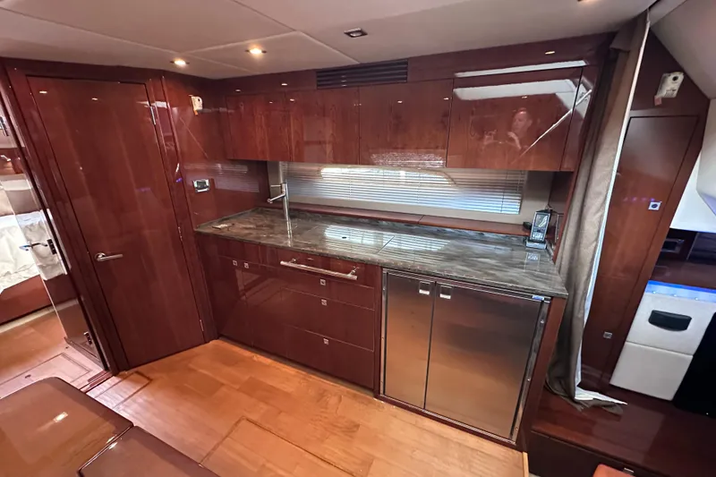 Slide: The Image of Luxurious kitchen interior of 2012 Sea Ray 450 Sundancer yacht with wood cabinetry. - 30