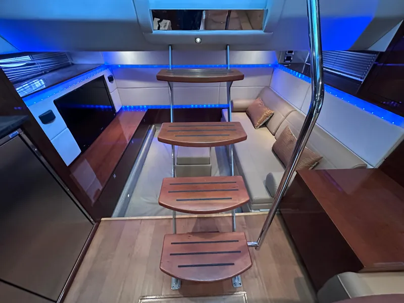 Slide: The Image of Luxurious interior of 2012 Sea Ray 450 Sundancer yacht with modern seating and ambient lighting. - 33