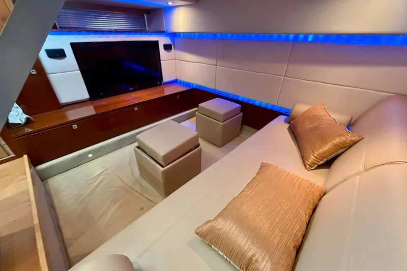 Slide: The Image of Luxurious interior of 2012 Sea Ray 450 Sundancer yacht with modern seating and ambient lighting. - 34