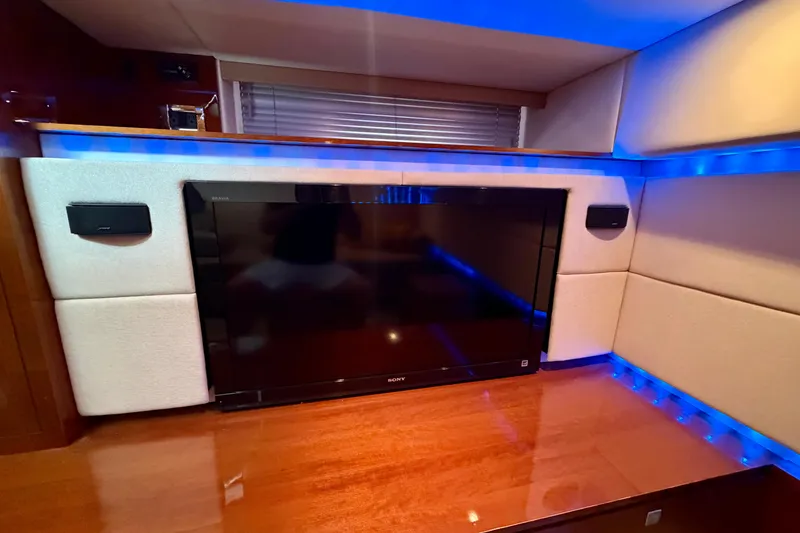 Slide: The Image of Luxurious interior of 2012 Sea Ray 450 Sundancer with TV and ambient blue lighting. - 35