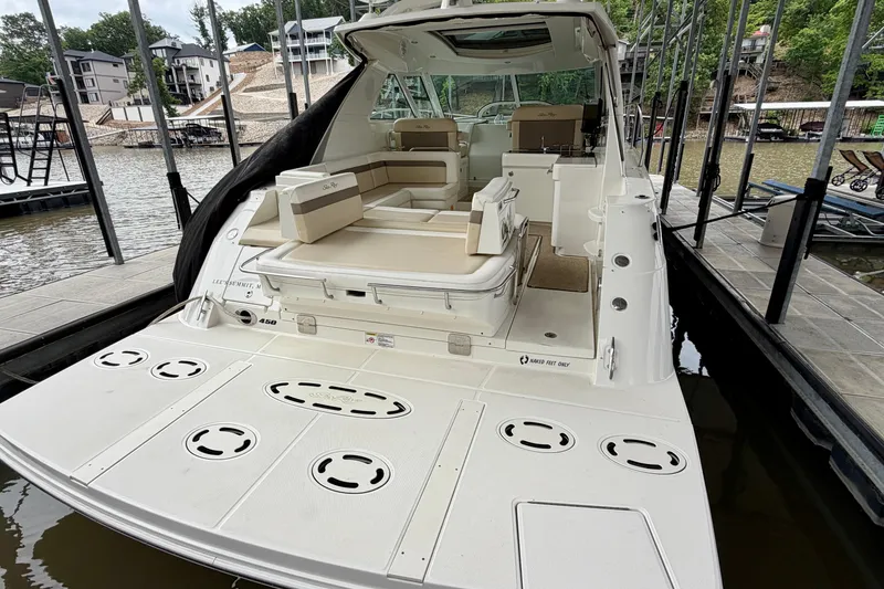 Slide: The Image of 2012 Sea Ray 450 Sundancer yacht docked, featuring spacious seating and sleek design. - 4