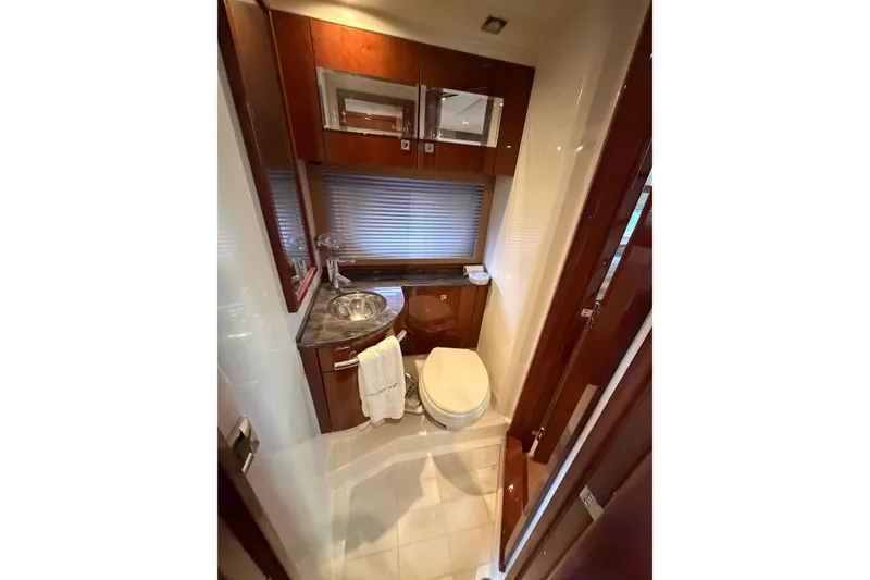 Slide: The Image of Luxurious bathroom in 2012 Sea Ray 450 Sundancer yacht with modern fixtures and wood accents. - 41