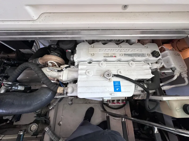Slide: The Image of Engine compartment of a 2012 Sea Ray 450 Sundancer boat, showcasing detailed machinery. - 46