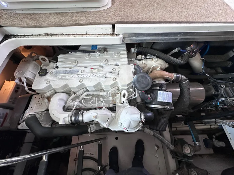 Slide: The Image of Engine compartment of a 2012 Sea Ray 450 Sundancer boat, featuring a Cummins engine. - 47