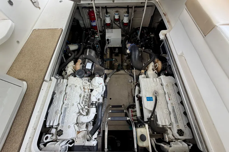 Slide: The Image of Engine compartment of a 2012 Sea Ray 450 Sundancer boat, showcasing dual engines. - 48