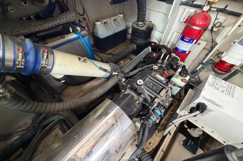 Slide: The Image of Engine room of a 2012 Sea Ray 450 Sundancer with visible components and fire extinguisher. - 49