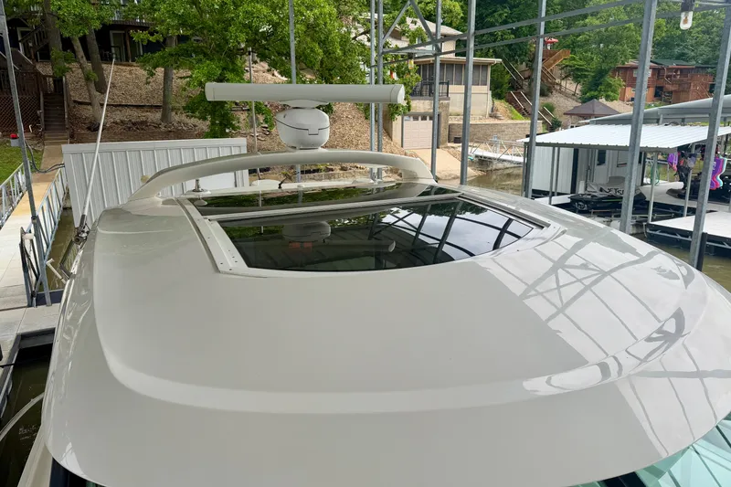 Slide: The Image of 2012 Sea Ray 450 Sundancer yacht docked, showcasing sleek design and radar equipment. - 5