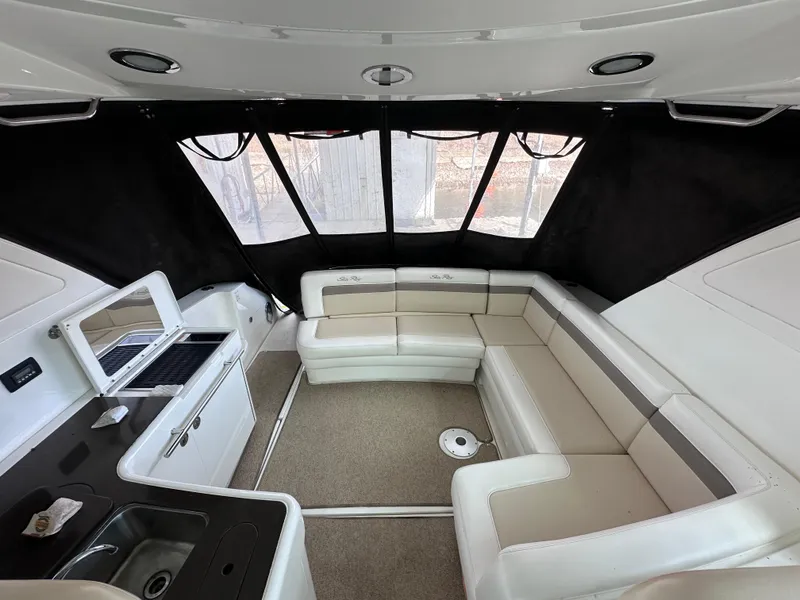 Slide: The Image of Interior of 2012 Sea Ray 450 Sundancer yacht with white seating and kitchenette. - 8