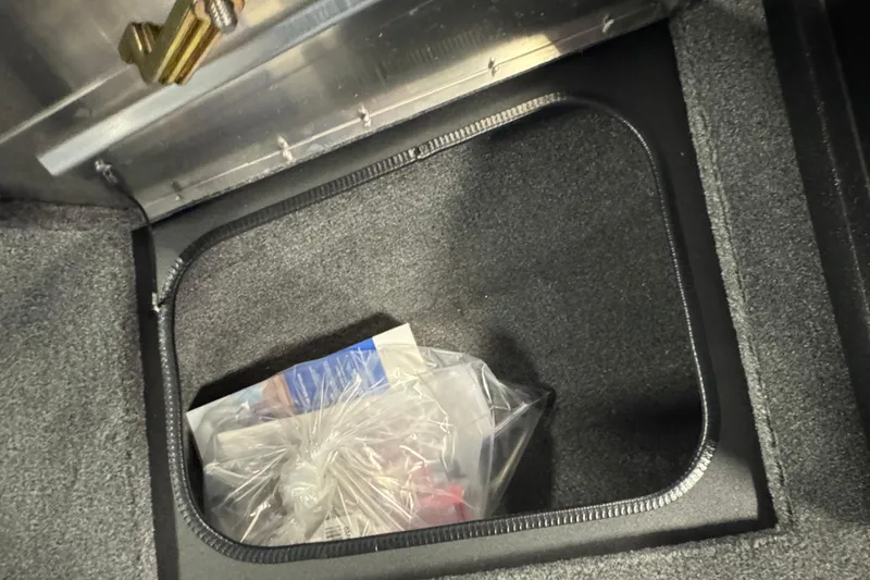 Slide: The Image of Storage compartment in 2026 Tracker Pro Guide V-175 WT boat, containing a plastic bag. - 15