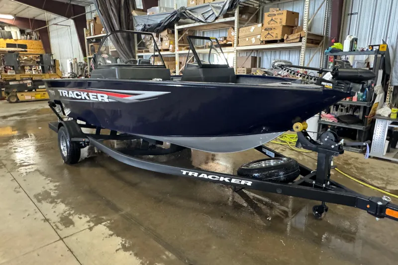 Slide: The Image of 2026 Tracker Pro Guide V-175 WT boat on trailer in a workshop setting. - 2