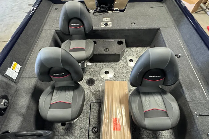 Slide: The Image of 2026 Tracker Pro Guide V-175 WT boat interior with gray seating and carpeted flooring. - 7