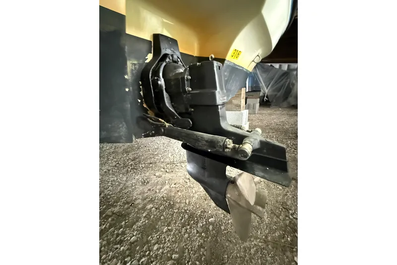 Slide: The Image of 2012 Bayliner 235 Bowrider boat stern drive and propeller detail in storage. - 10