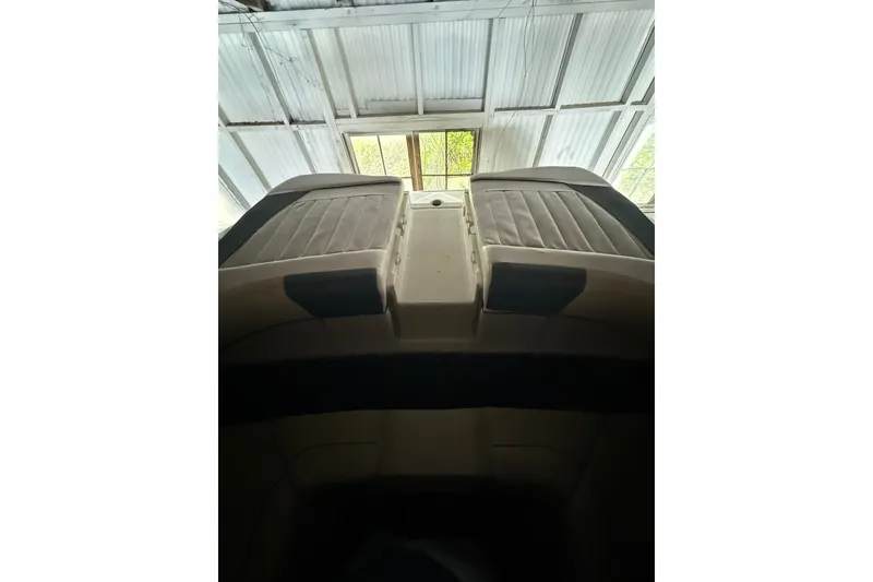 Slide: The Image of 2012 Bayliner 235 Bowrider interior view under a metal roof. - 15