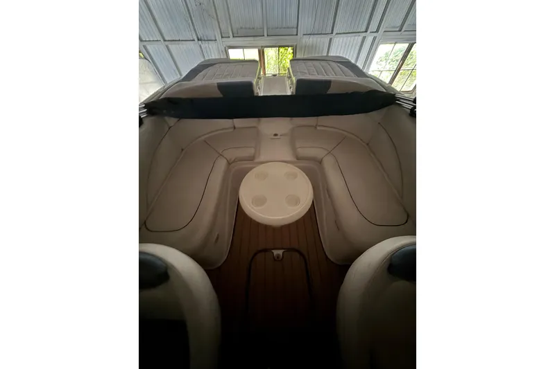 Slide: The Image of Interior of 2012 Bayliner 235 Bowrider boat with seating and table. - 16
