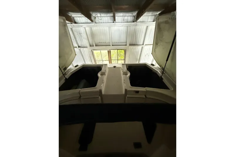 Slide: The Image of 2012 Bayliner 235 Bowrider boat interior with open storage compartments. - 20