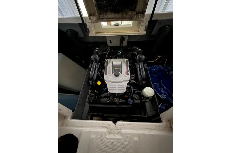 Slide: The Image of Engine compartment of a 2012 Bayliner 235 Bowrider boat, showcasing the motor. - 21