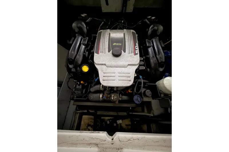 Slide: The Image of Engine compartment of a 2012 Bayliner 235 Bowrider boat, featuring a 5.0L MerCruiser engine. - 22
