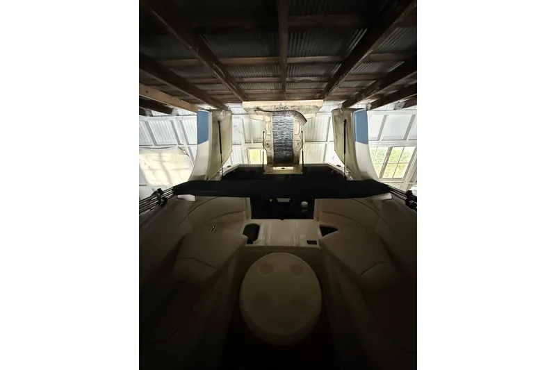 Slide: The Image of Interior view of a 2012 Bayliner 235 Bowrider boat in storage. - 25