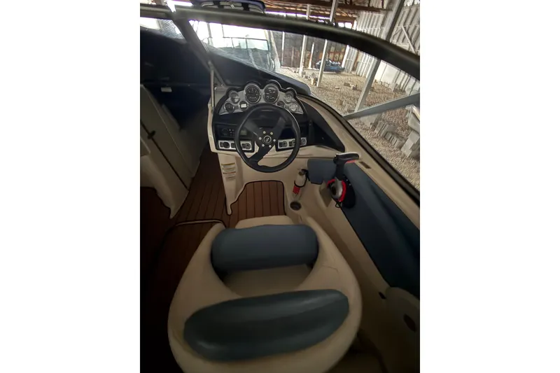 Slide: The Image of Interior view of 2012 Bayliner 235 Bowrider boat cockpit with steering wheel and controls. - 27