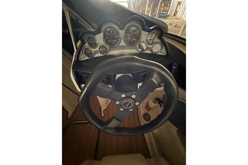 Slide: The Image of Steering wheel and dashboard of 2012 Bayliner 235 Bowrider boat. - 29