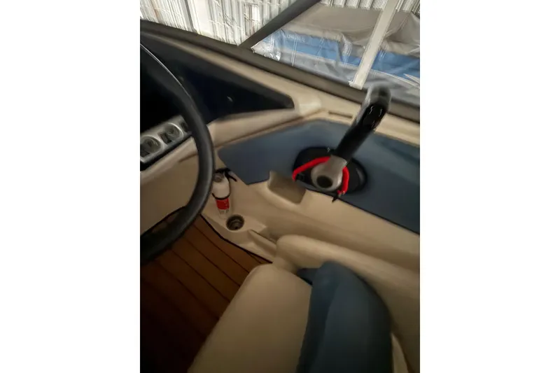 Slide: The Image of Interior view of 2012 Bayliner 235 Bowrider boat cockpit with steering wheel and controls. - 30