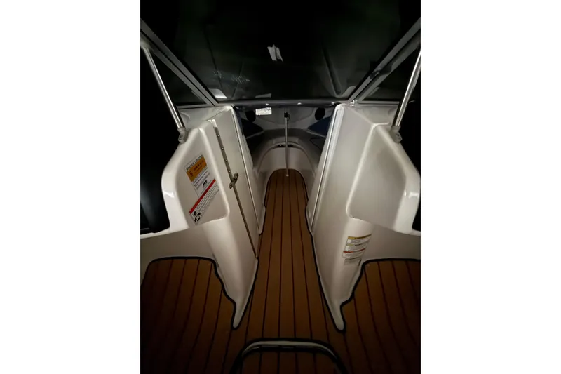 Slide: The Image of 2012 Bayliner 235 Bowrider interior with wood flooring and sleek design. - 33