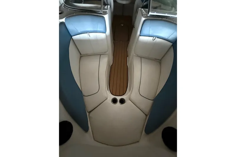 Slide: The Image of Interior view of 2012 Bayliner 235 Bowrider boat with blue and white seating. - 39