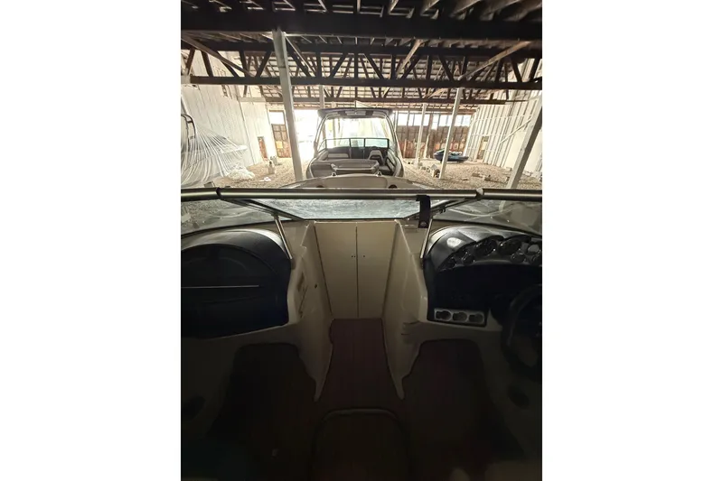 Slide: The Image of 2012 Bayliner 235 Bowrider interior view in a storage facility. - 43