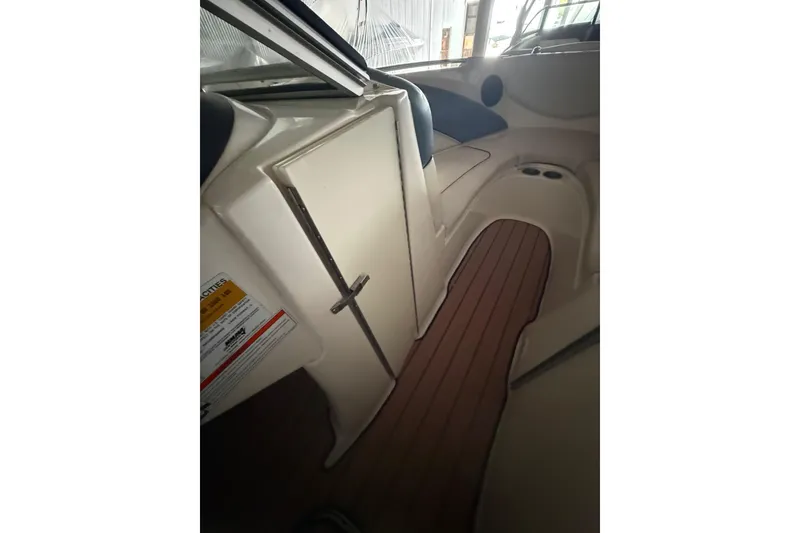 Slide: The Image of Interior view of 2012 Bayliner 235 Bowrider, featuring seating and storage compartments. - 44